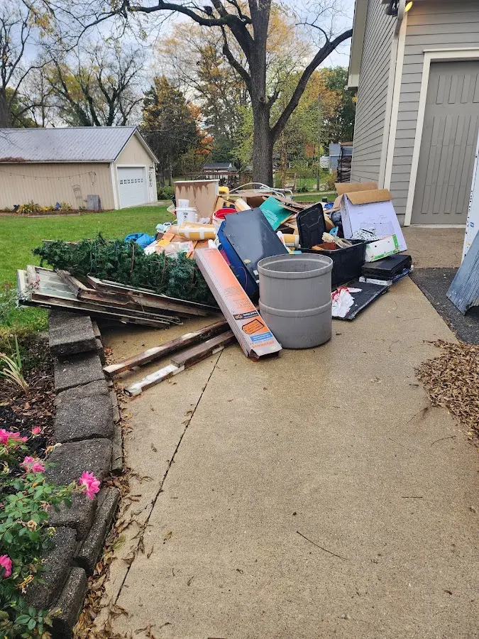Dumpster being loaded with debris for 3 Yard Dumpster Rental in Overland Park